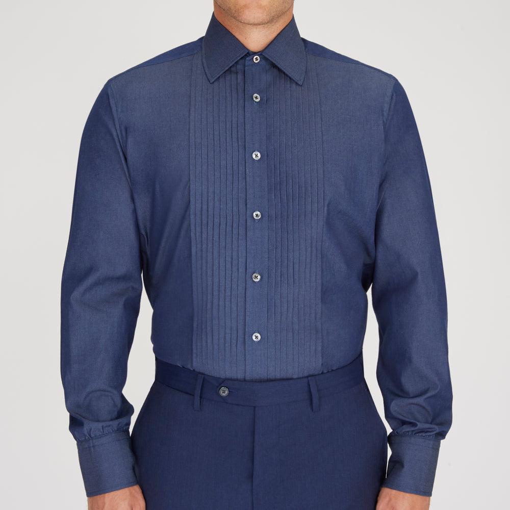 A neatly folded Turnbull & Asser Dark Blue Denim-Cashmere Dress Shirt with T&A collar and 3-button cuffs, showcased on a plain light background, offers a refined formal alternative.