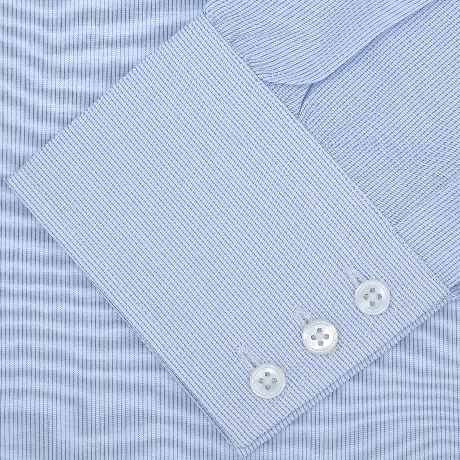 View 2 of product The Turnbull & Asser Blue Hairline Stripe Shirt features a T&A collar and 3-button cuffs, neatly folded with white buttons, shown on a plain white background—ideal as an office shirt.
