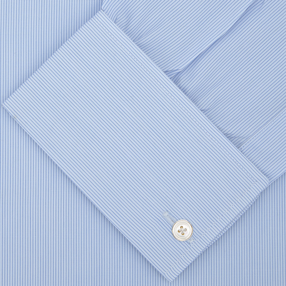The Turnbull & Asser Blue Hairline Stripe Shirt features a T&A collar, double cuffs, white buttons, and a crisp design—ideal for the office. Displayed neatly folded on a plain white background.