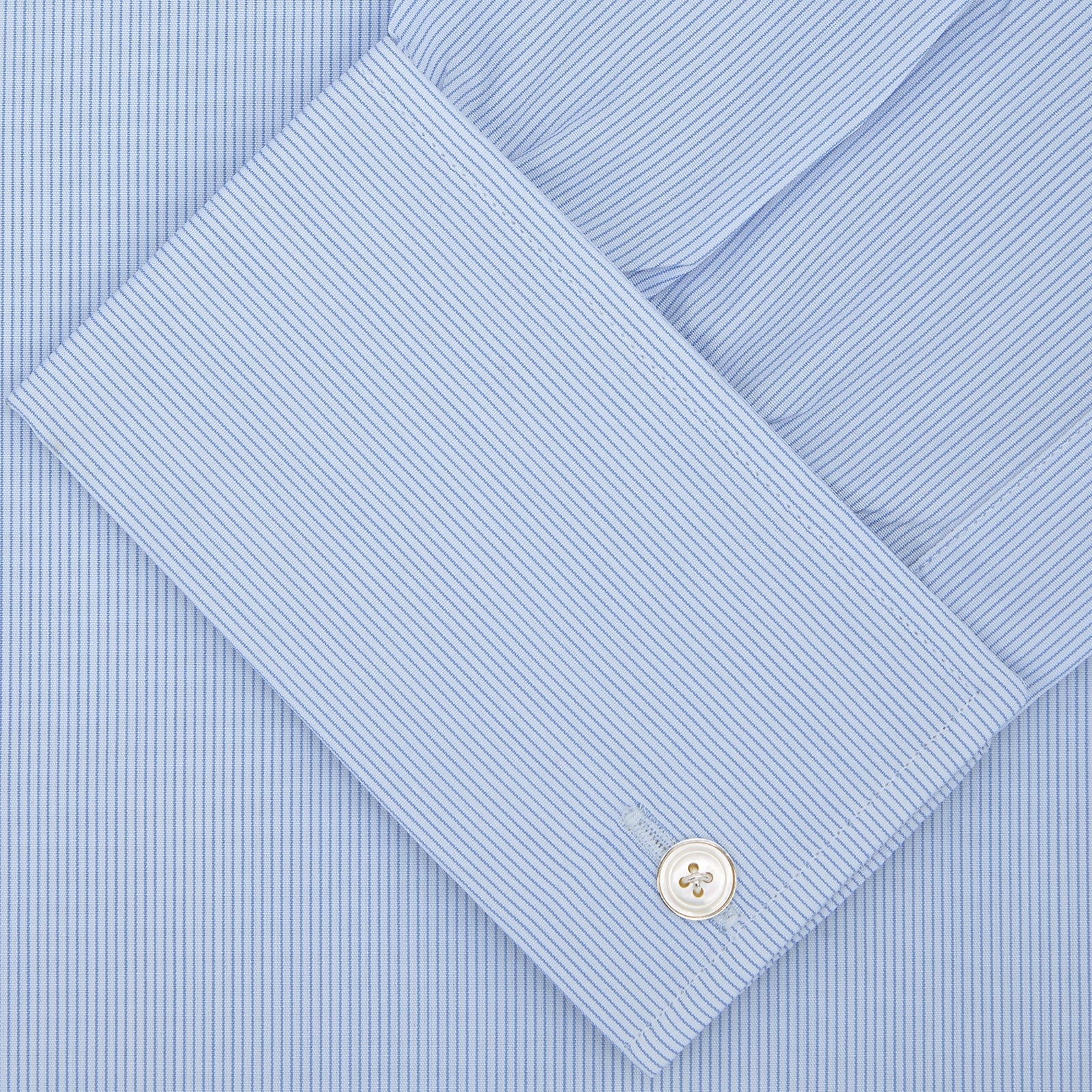 View 2 of product The Turnbull & Asser Blue Hairline Stripe Shirt features a T&A collar, double cuffs, white buttons, and a crisp design—ideal for the office. Displayed neatly folded on a plain white background.