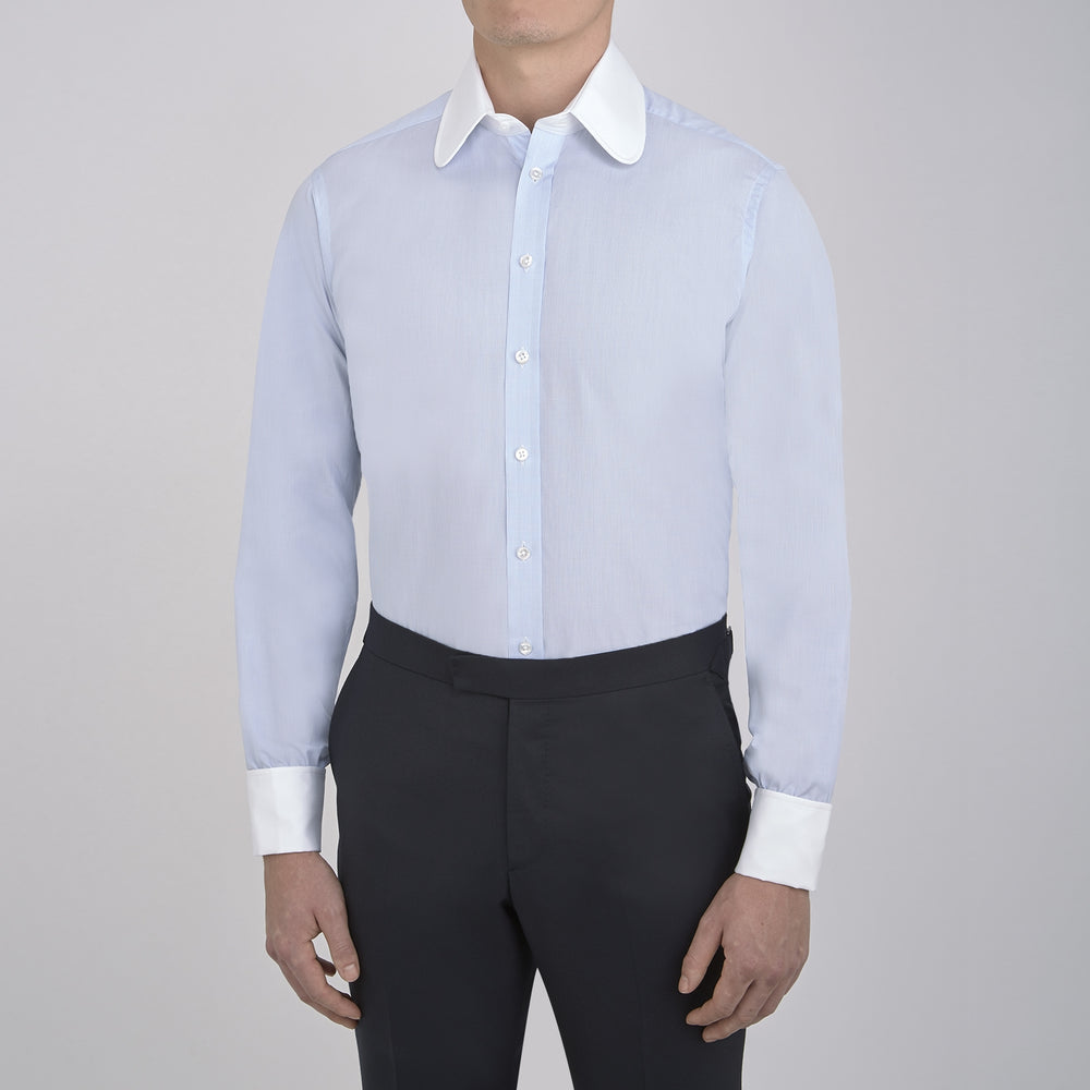 A neatly folded The Great Gatsby Cotton Shirt by Turnbull & Asser, featuring a light blue body, white rounded collar, and double cuffs inspired by 1920s style, displayed on a plain light background.