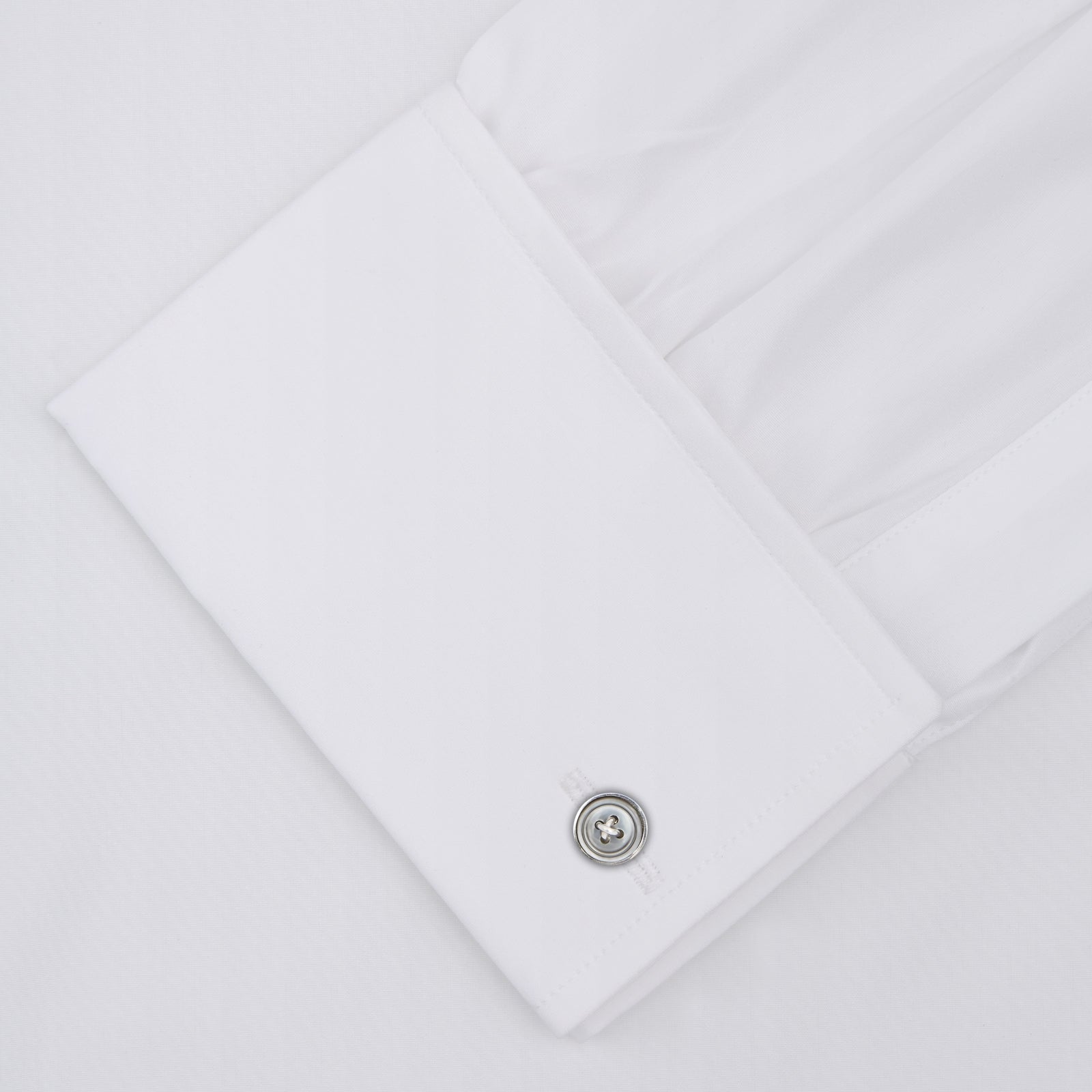 View 2 of product The Turnbull & Asser Two-Fold 120 White Cotton Shirt features long sleeves, a regent collar, double cuffs, and white buttons, neatly displayed against a light blue background.
