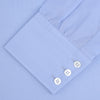 View 4 of product The Turnbull & Asser Two-Fold 200 Blue Cotton Shirt features a T&A collar, 3-button cuffs, and white buttons—a refined men's dress shirt displayed on a plain white background.