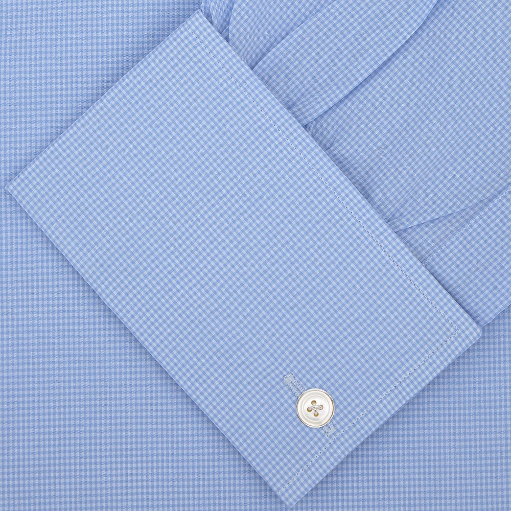 A Turnbull & Asser Sky Blue Micro-Check Shirt with T&A collar, double cuffs, and white buttons is neatly folded and displayed against a plain white background.