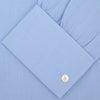 View 2 of product The Turnbull & Asser Light Blue Herringbone Superfine Cotton Shirt features a T&A collar, double cuffs, and is neatly folded against a plain white background.