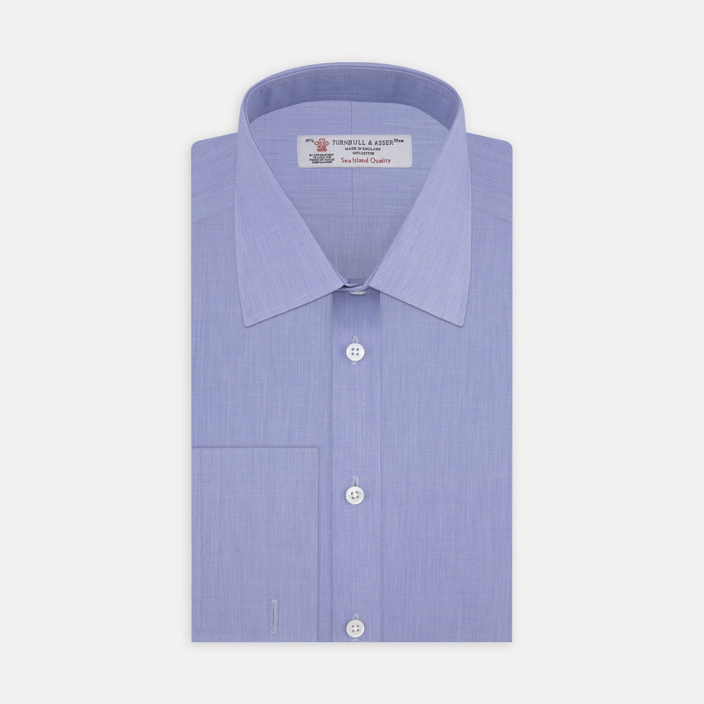 A neatly folded dark blue Sea Island quality cotton shirt by Turnbull & Asser, featuring a T&A collar, double cuffs, and white buttons, is displayed against a plain white background.