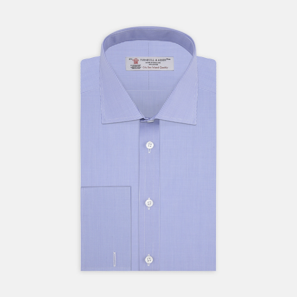 The Turnbull & Asser Blue Fine Check Sea Island Quality Cotton Shirt features a Regent collar, double cuffs, a subtle checkered pattern, and white buttons, displayed neatly folded on a white background.
