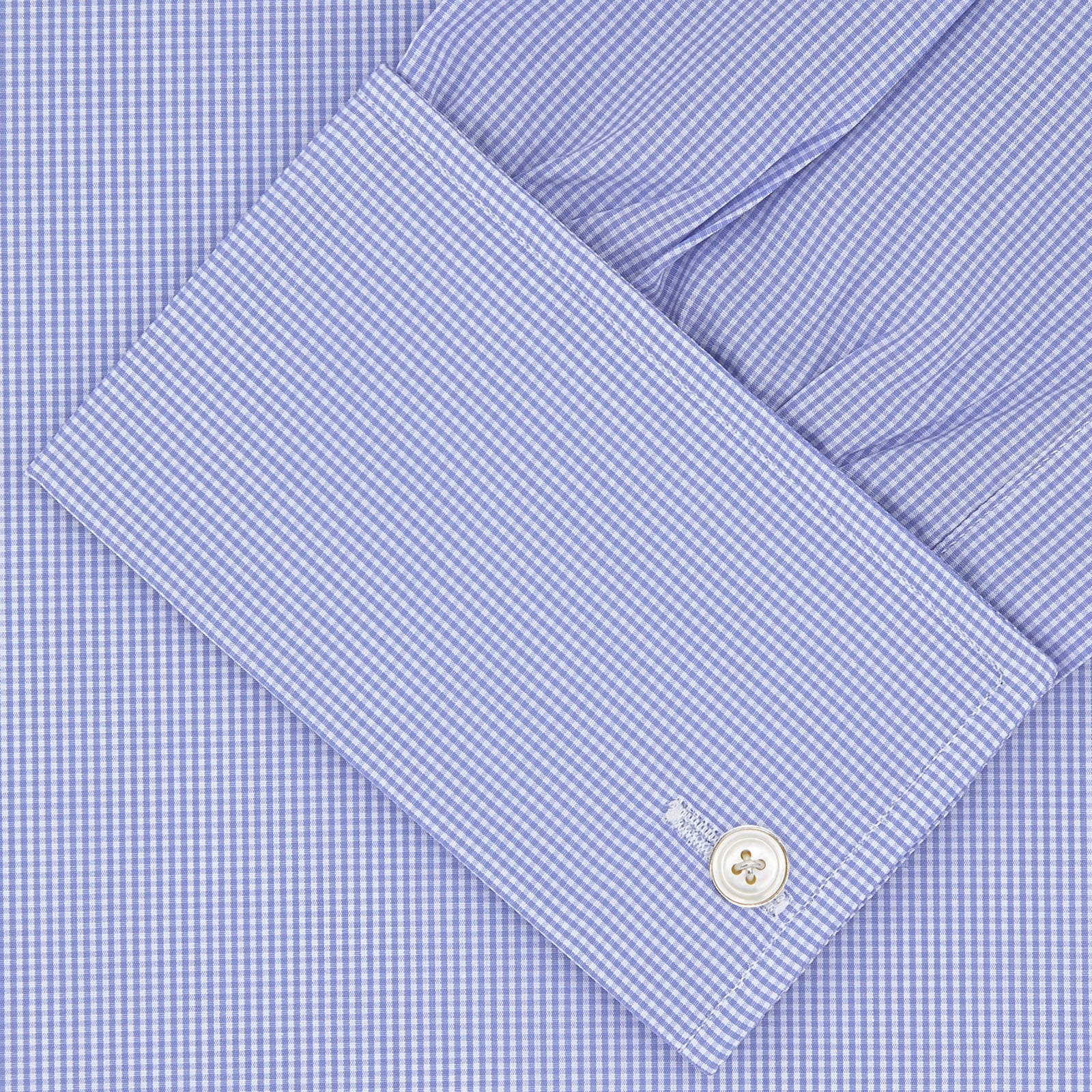 View 2 of product The Turnbull & Asser Blue Fine Check Sea Island Quality Cotton Shirt features a Regent collar, double cuffs, a subtle checkered pattern, and white buttons, displayed neatly folded on a white background.