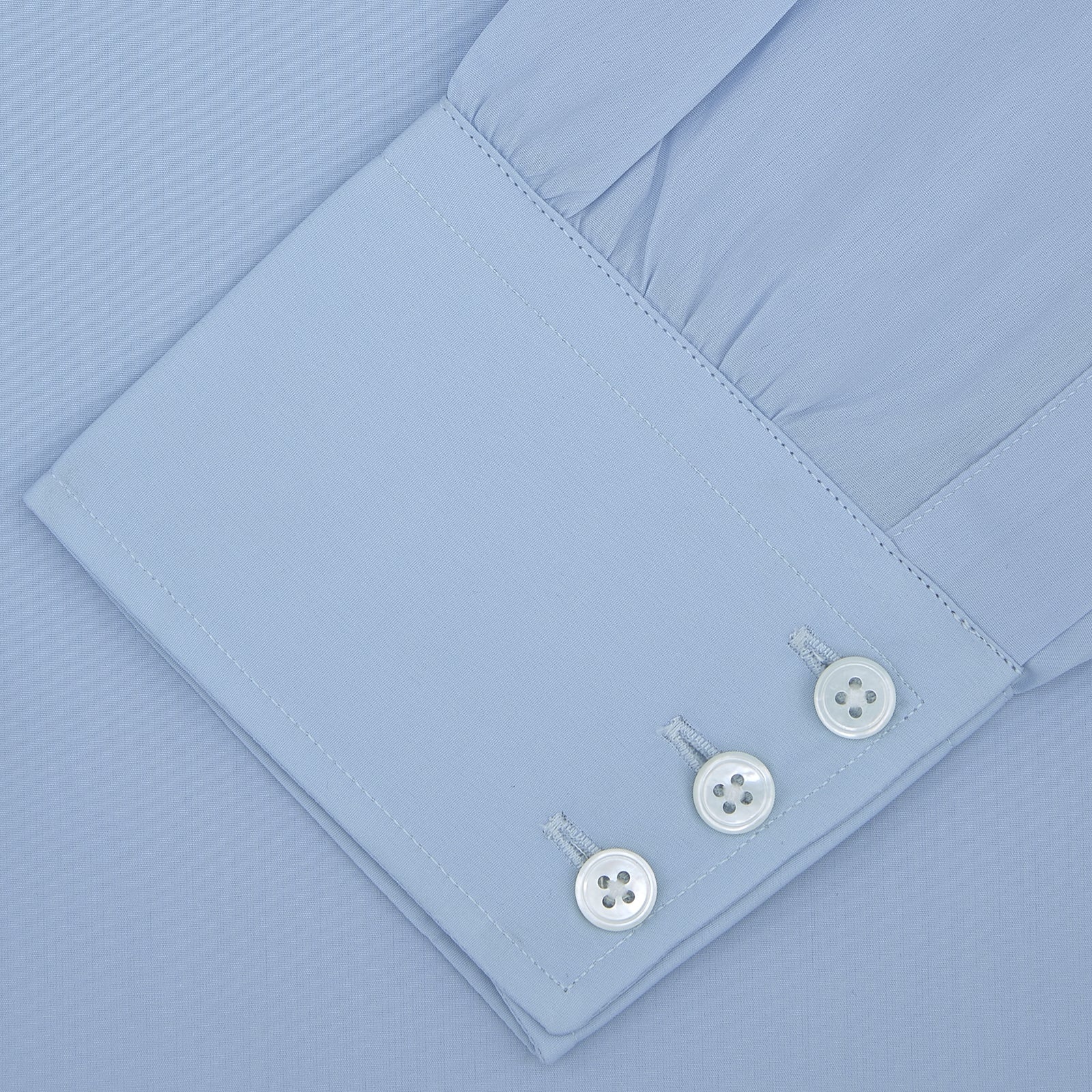 View 2 of product The Turnbull & Asser Blue Sea Island Quality Cotton Shirt features a Dr. No collar and button cuffs, crafted from fine cotton and shown neatly folded on a plain white background.