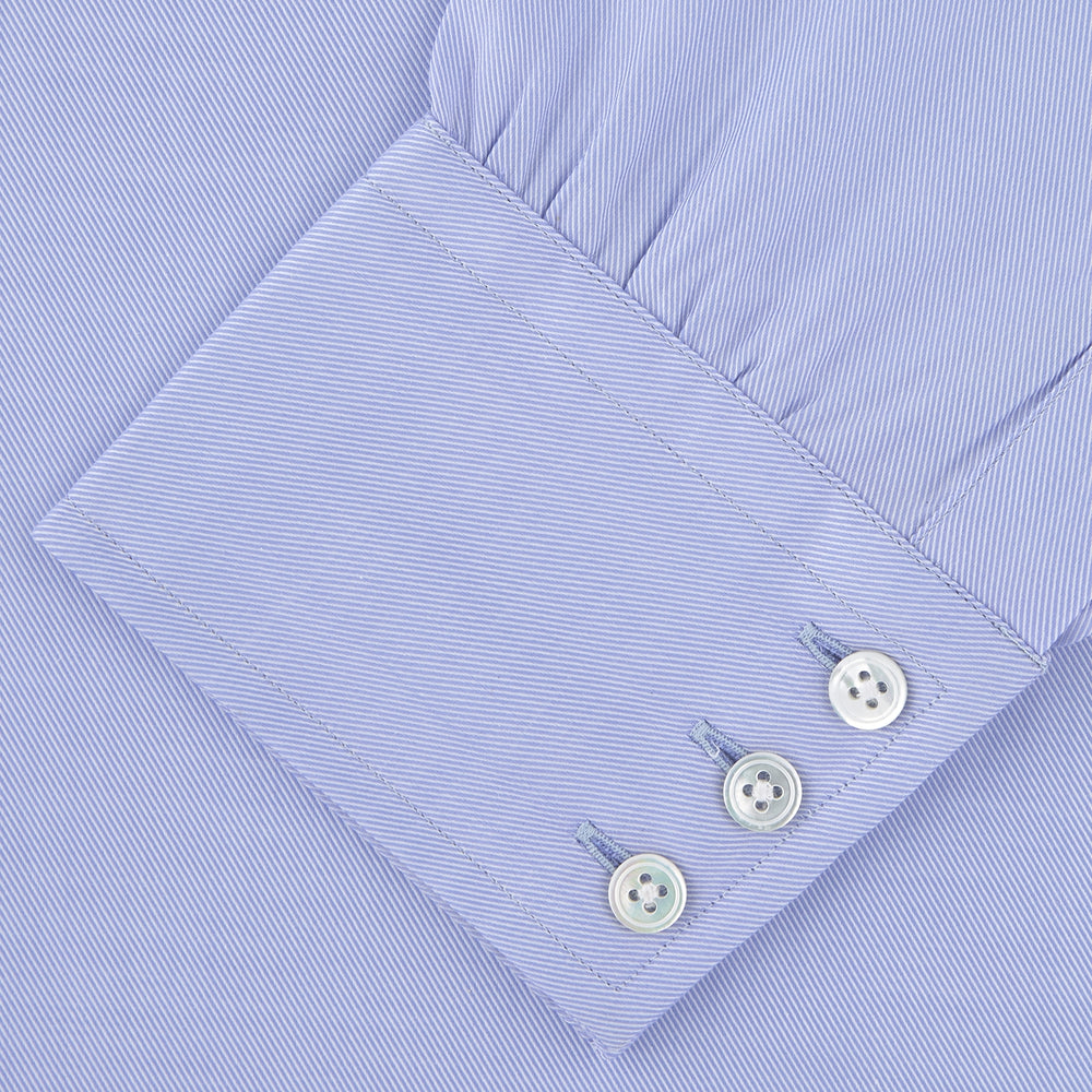 The Turnbull & Asser Blue Sea Island Quality Cotton Twill Shirt features a T&A collar, chest pocket, white buttons, and 3-button cuffs, all showcased on a plain white background.