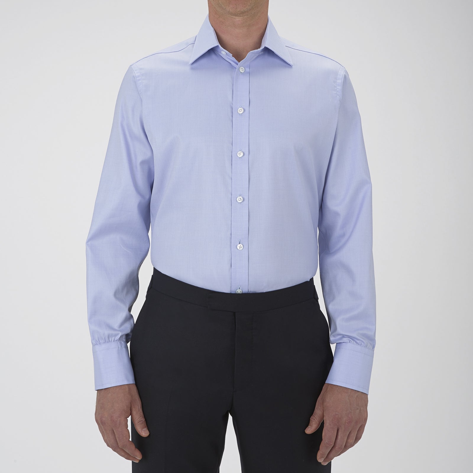 View 2 of product The Turnbull & Asser Blue Sea Island Quality Cotton Twill Shirt features a T&A collar, chest pocket, white buttons, and 3-button cuffs, all showcased on a plain white background.