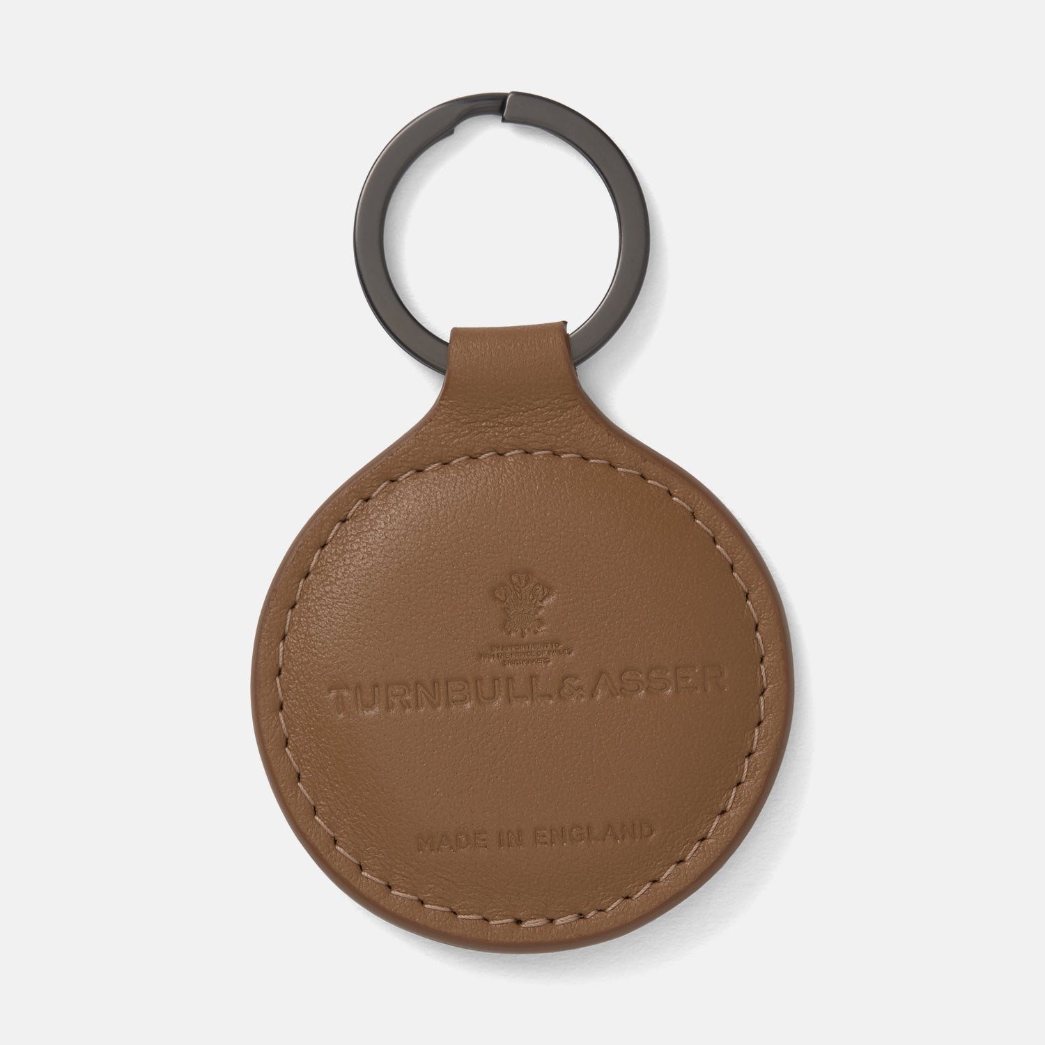 View 1 of product The Peanut Brown Leather Key Fob by Turnbull & Asser features embossed branding, MADE IN ENGLAND details, and a dark metal keyring.