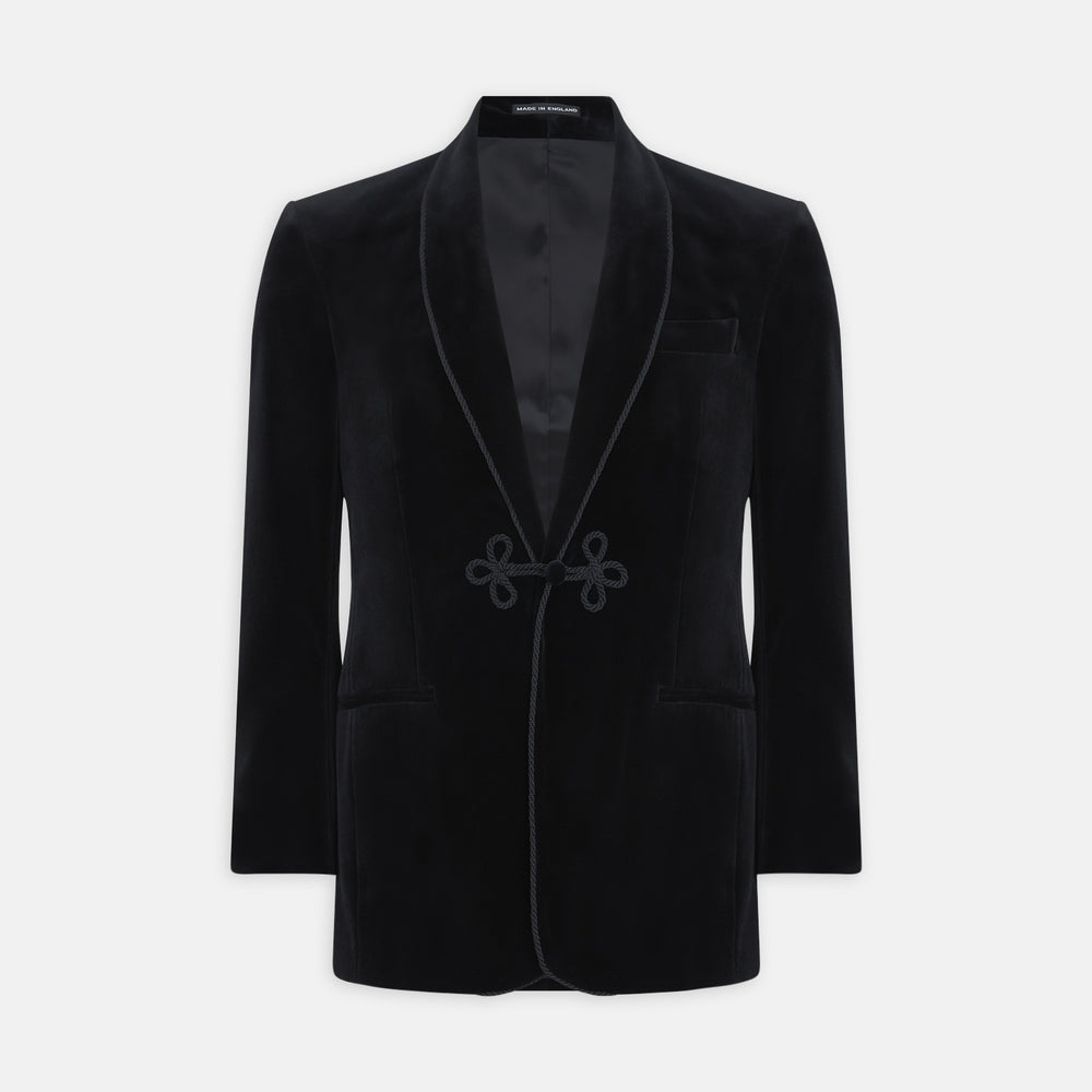The Turnbull & Asser Black Single Breasted Velvet Smoking Jacket features a shawl collar, satin lining, two front pockets, and a knotted closure—ideal for stylish eveningwear.