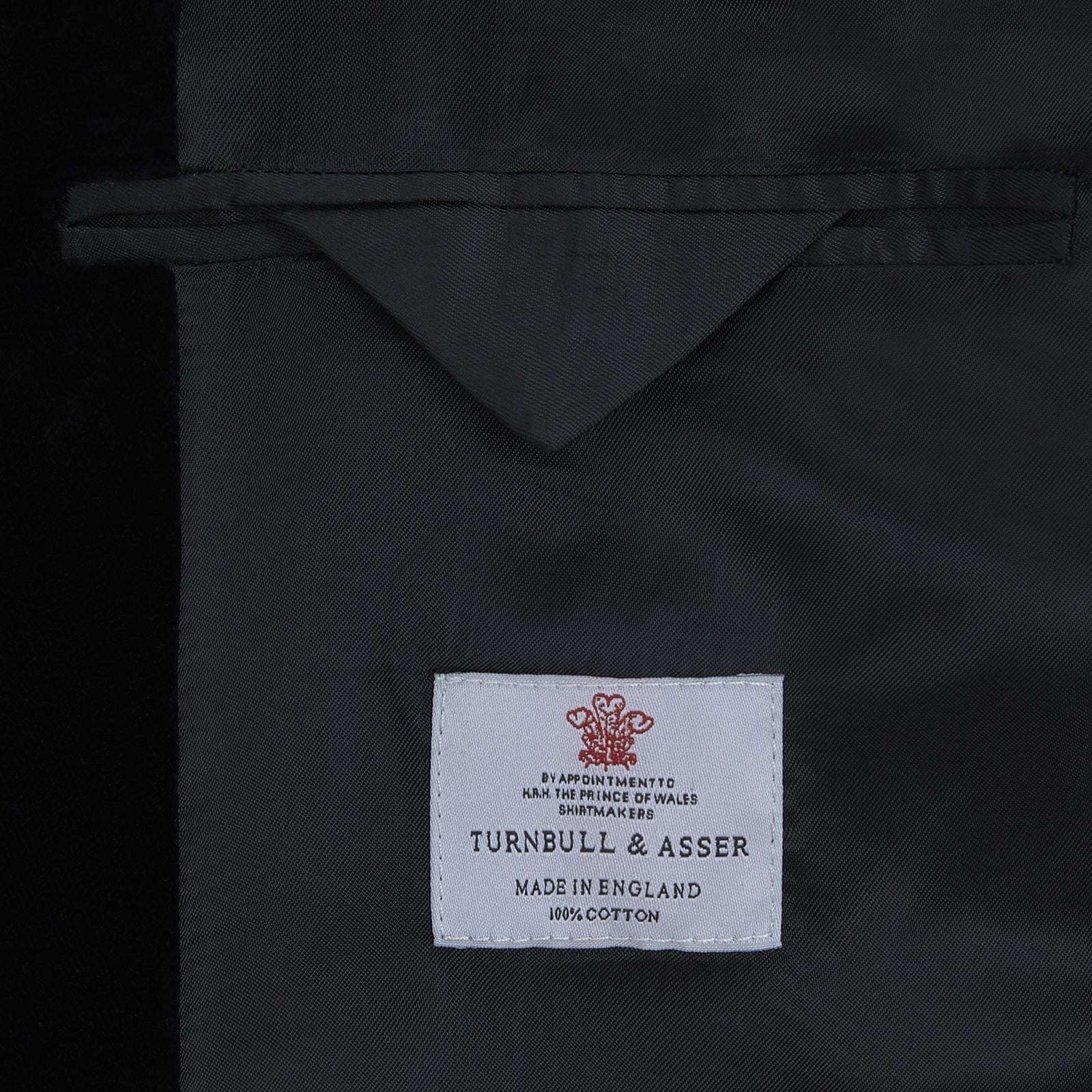 View 2 of product The Turnbull & Asser Black Single Breasted Velvet Smoking Jacket features a shawl collar, satin lining, two front pockets, and a knotted closure—ideal for stylish eveningwear.