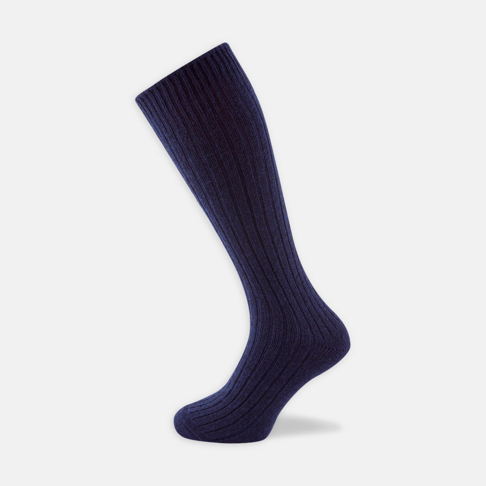 A single Turnbull & Asser Navy 3/4 Length Cashmere Sock is displayed on a white background, featuring a ribbed, fitted shape with subtle texture and breathable comfort for all-day wear.