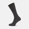 View 1 of product The Turnbull & Asser Dark Grey Mid-Length Merino Wool Sock, ideal as a men’s dress sock, is showcased upright against a plain light gray background.