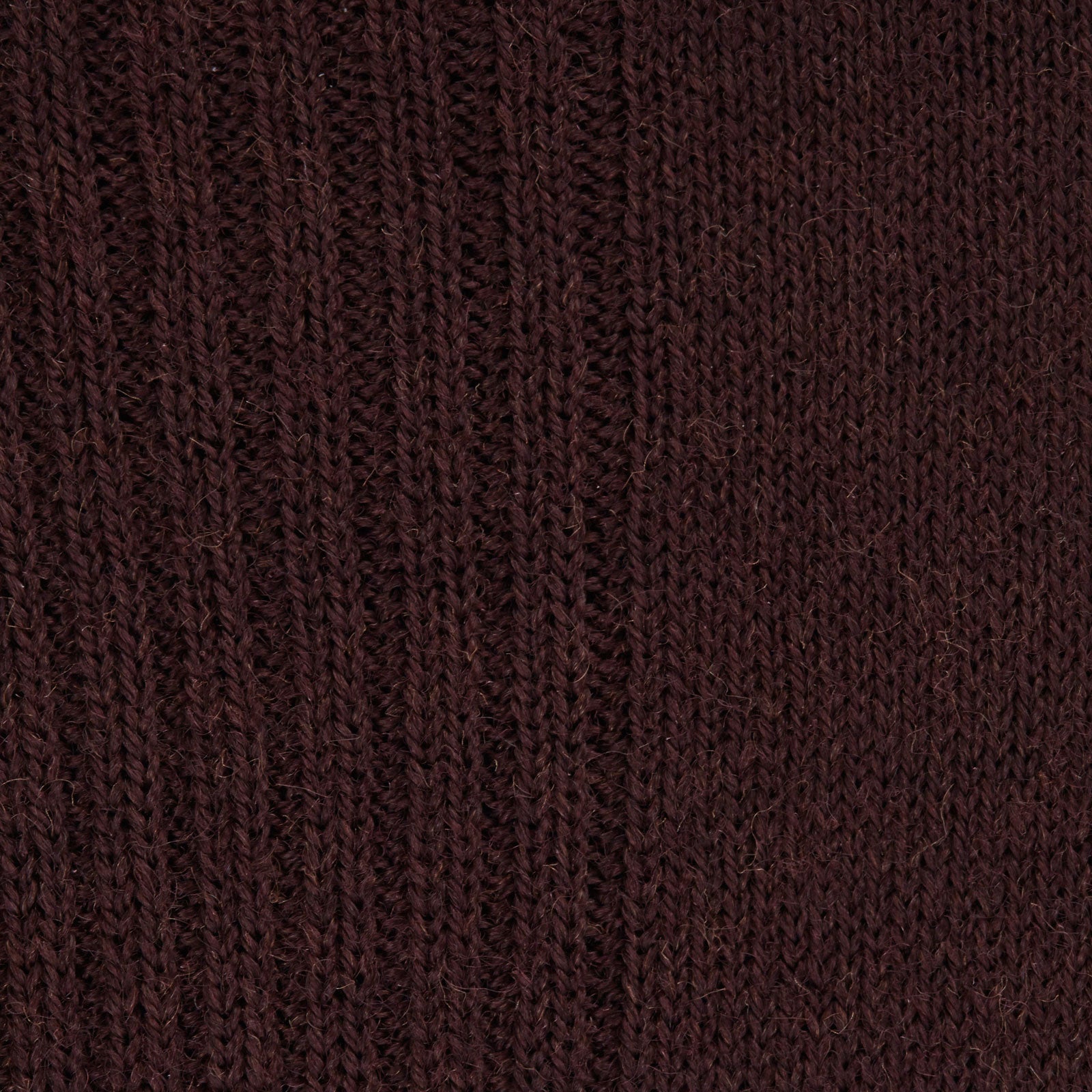View 2 of product A single maroon mid-length Merino wool sock from Turnbull & Asser stands upright on a plain light gray background, highlighting its ribbed texture.
