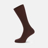 View 1 of product A single maroon mid-length Merino wool sock from Turnbull & Asser stands upright on a plain light gray background, highlighting its ribbed texture.