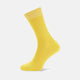 A single Yellow Short Cotton Sock by Turnbull & Asser, crafted from soft Egyptian cotton with ribbed texture and solid yellow cuff, heel, and toe, stands upright on a plain white background—a staple for any luxury sock collection.