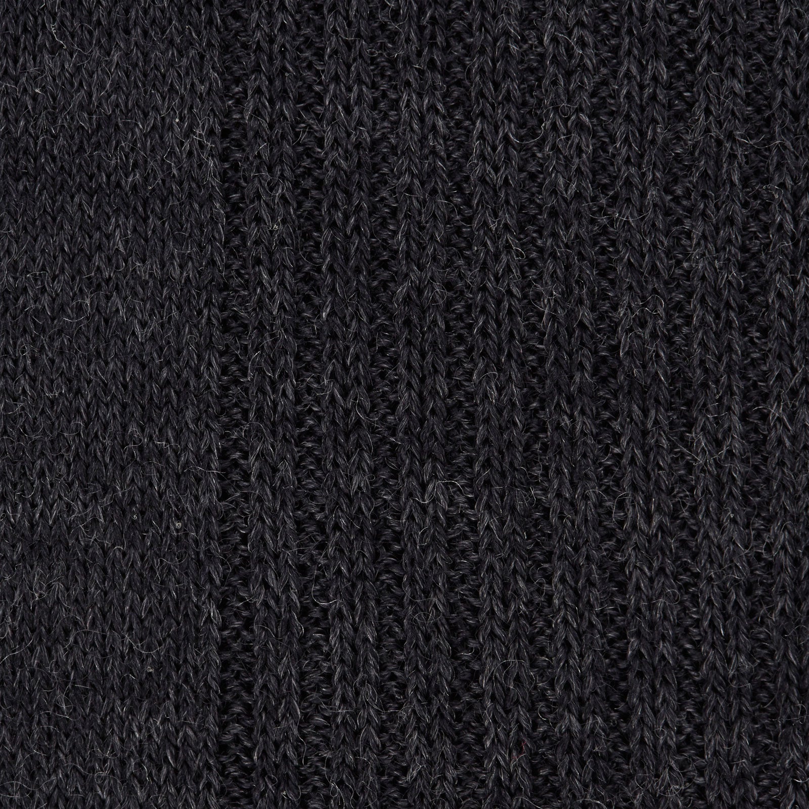 View 2 of product A single Charcoal Long Merino Wool Sock by Turnbull & Asser is shown upright on a white background. Featuring a ribbed texture and snug fit, these luxury men's socks blend style with comfort.