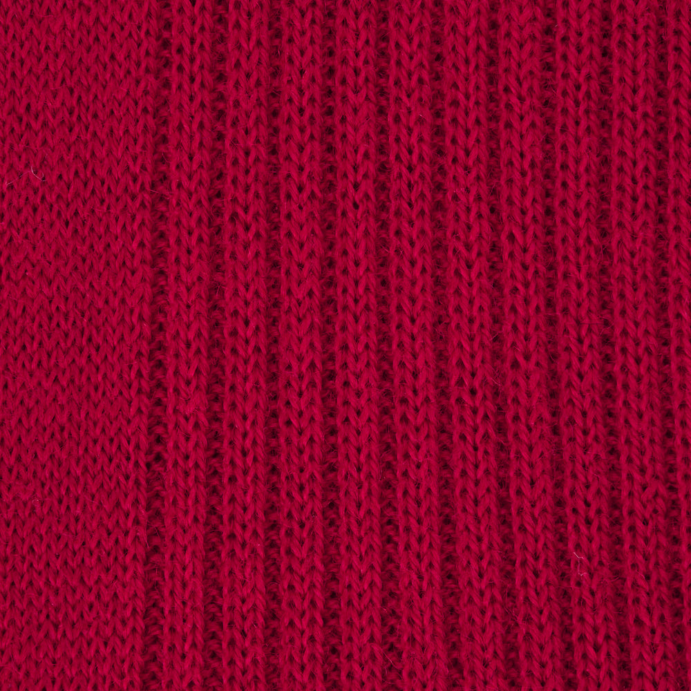 A single Red Long Merino Wool Sock by Turnbull & Asser stands upright against a light gray background, highlighting the elegance and luxury of premium men’s socks.