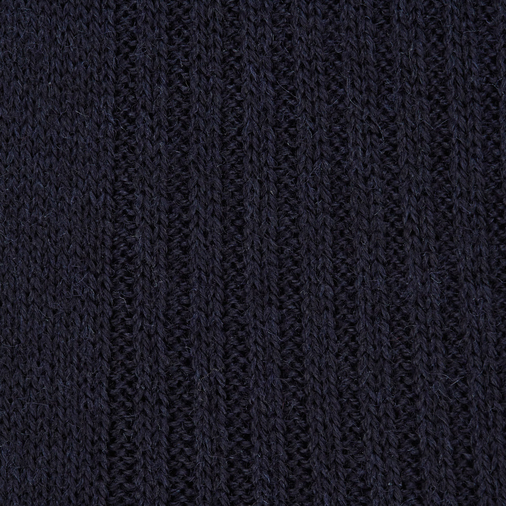 A single Deep Navy Long Merino Wool Sock by Turnbull & Asser is shown on a mannequin leg against a plain light gray background.
