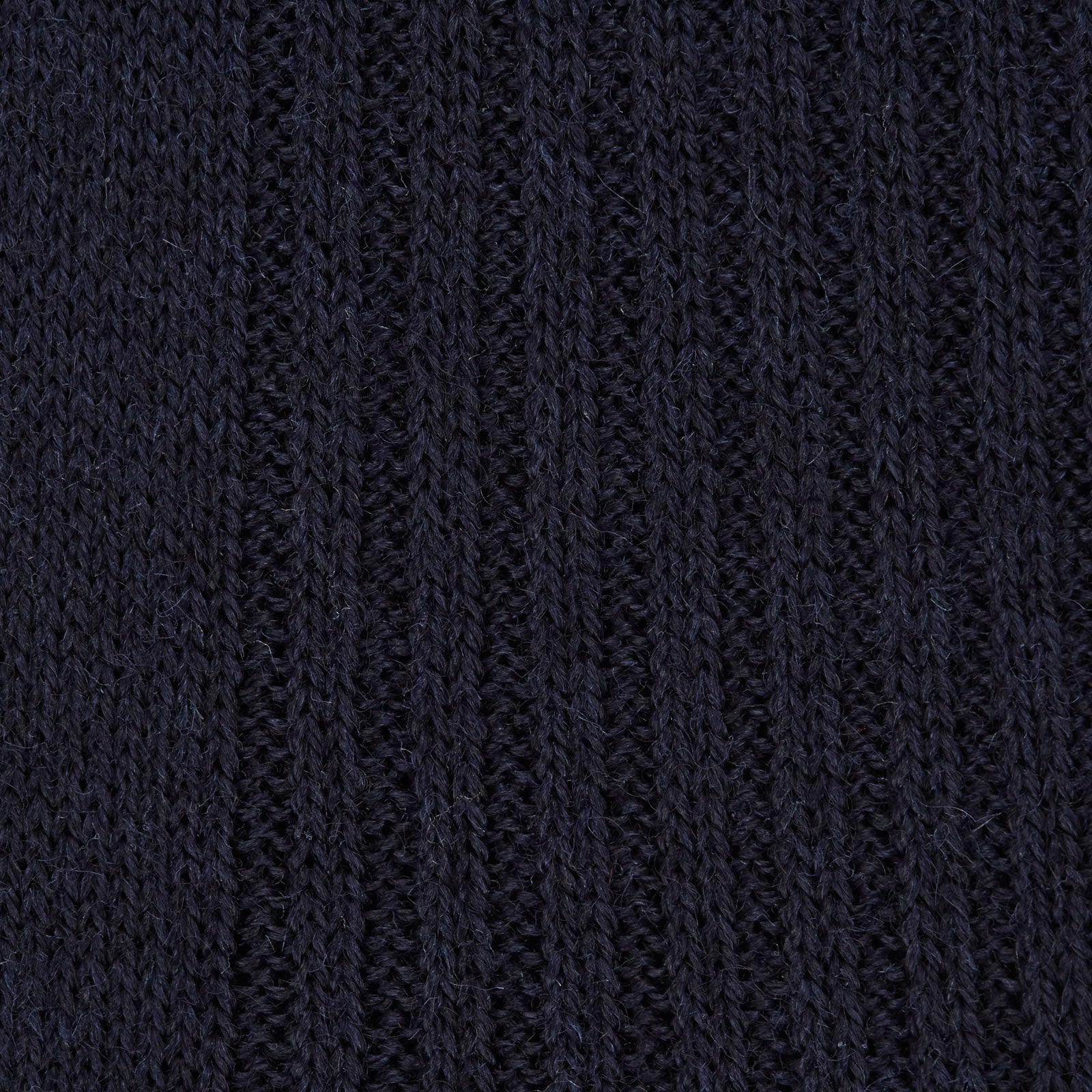 View 2 of product A single Deep Navy Long Merino Wool Sock by Turnbull & Asser is shown on a mannequin leg against a plain light gray background.