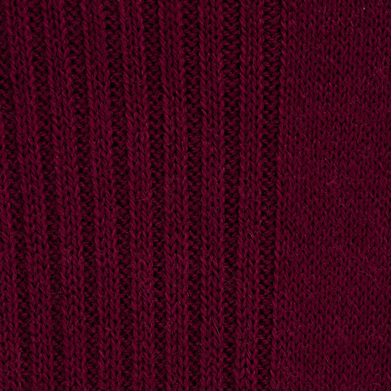 View 2 of product A single Bordeaux Long Merino Wool Sock by Turnbull & Asser stands upright on a light gray background, showcasing the brand’s luxurious men’s sock style.