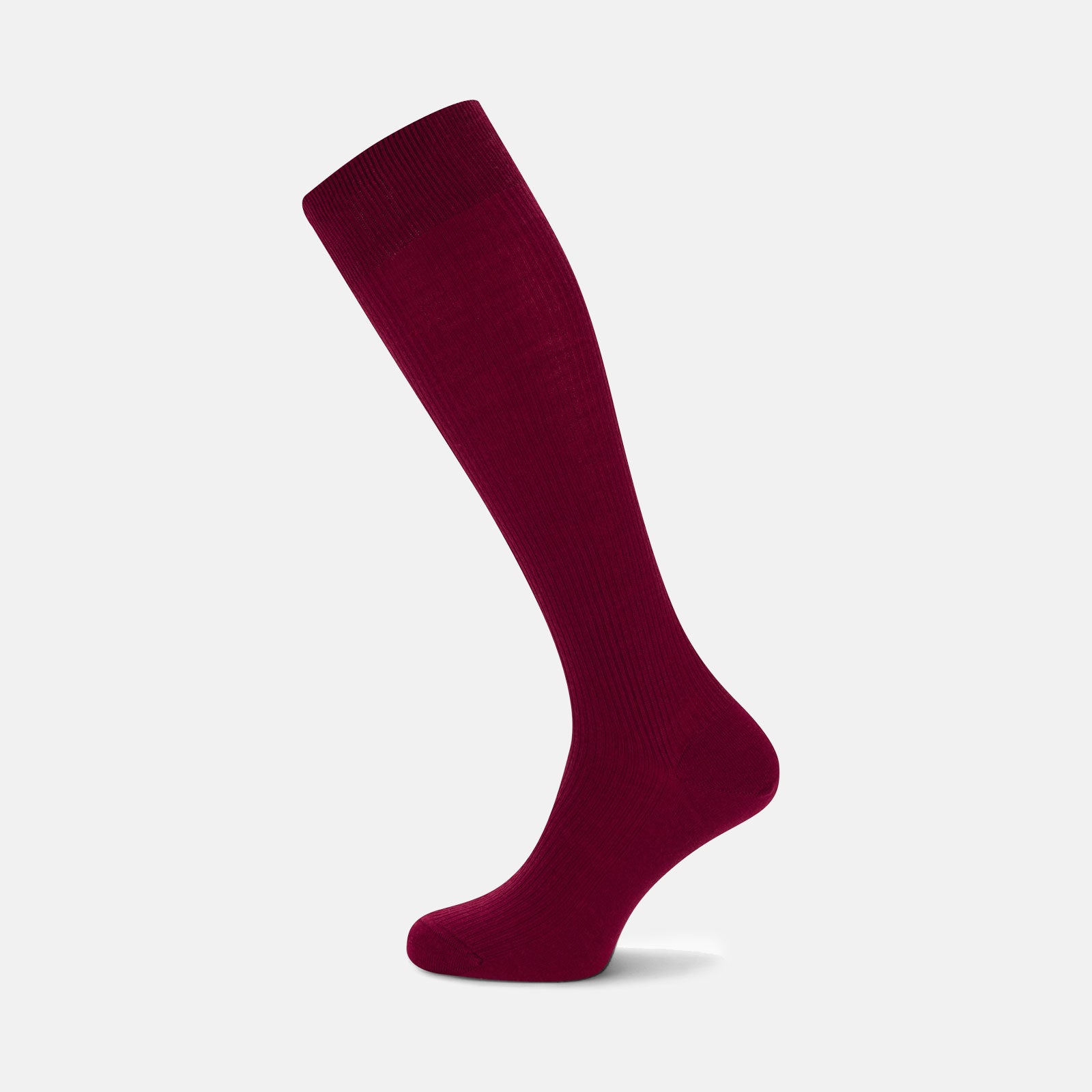 View 1 of product A single Bordeaux Long Merino Wool Sock by Turnbull & Asser stands upright on a light gray background, showcasing the brand’s luxurious men’s sock style.
