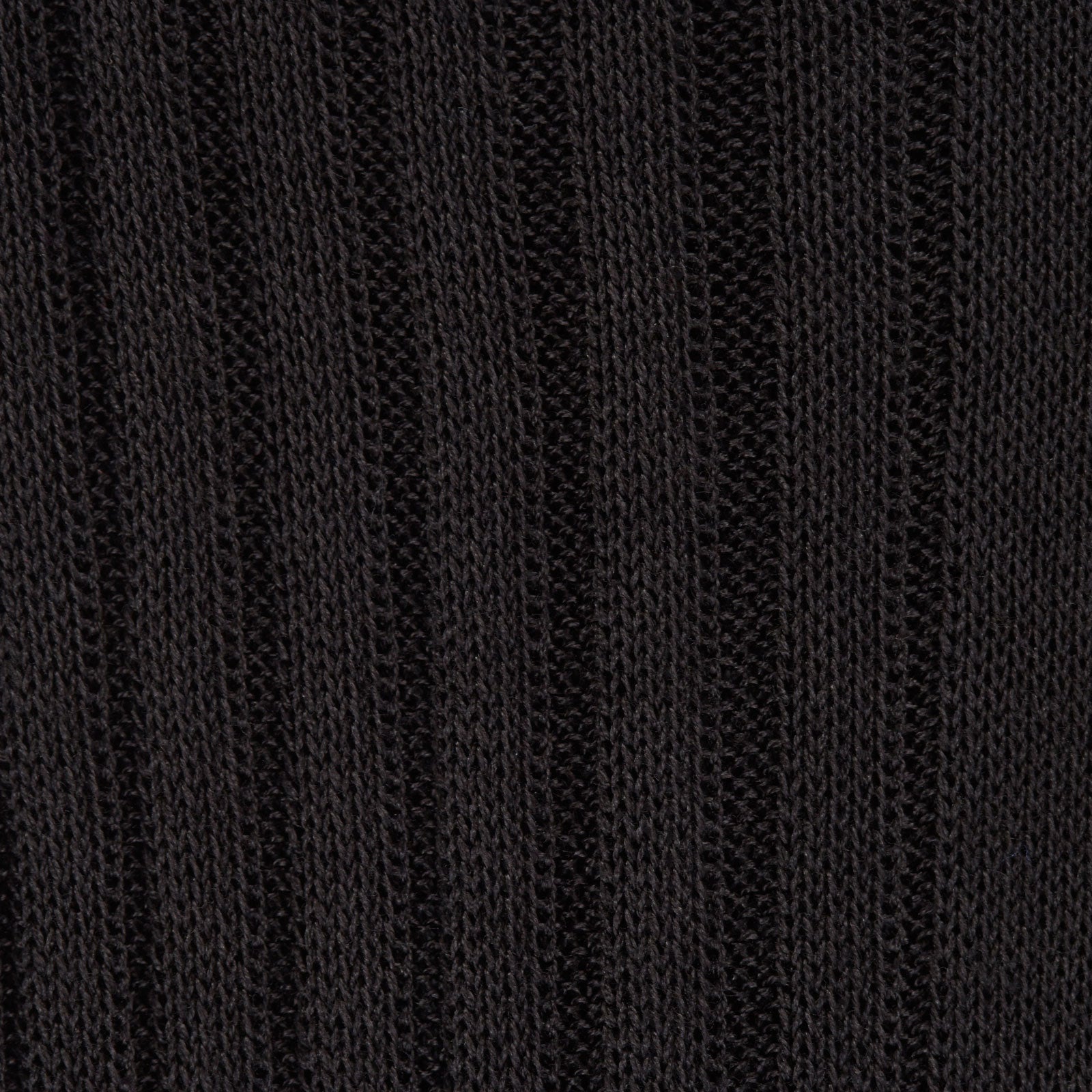 View 2 of product A single Charcoal Long Cotton Sock by Turnbull & Asser, in black Egyptian cotton, is shown against a plain white background at an angle with the foot pointing downward and the leg extending upward.