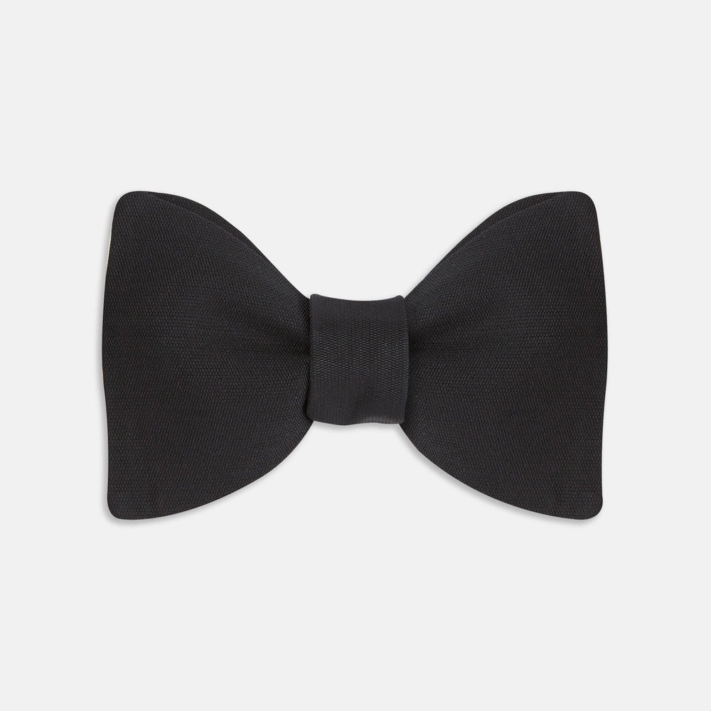 The Turnbull & Asser Black Barathea Bow Tie, made from luxurious silk with a classic, symmetrical shape, is displayed against a plain white background—ideal for formal occasions.