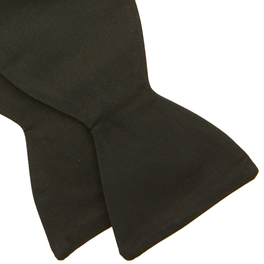 The Turnbull & Asser Black Barathea Bow Tie, made from luxurious silk with a classic, symmetrical shape, is displayed against a plain white background—ideal for formal occasions.