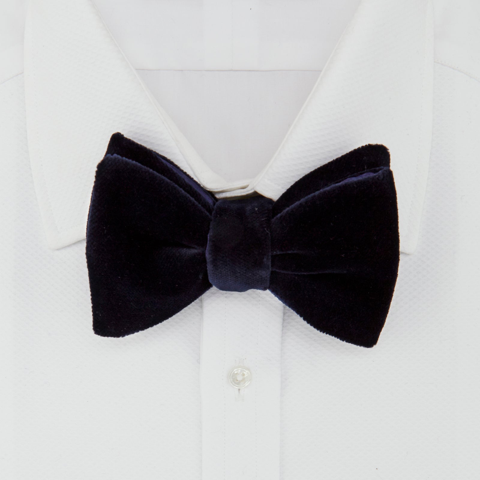 View 2 of product The Turnbull & Asser Navy Velvet Bow Tie, crafted from plush velvet, is shown against a white background—an elegant choice for formal occasions.
