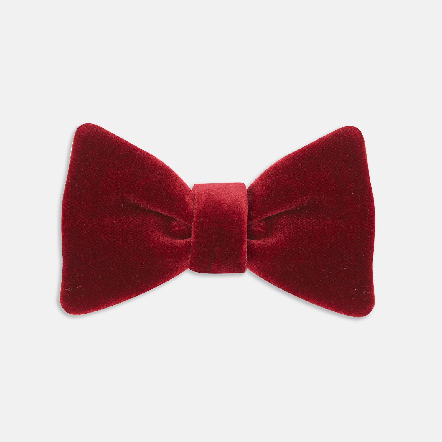 View 1 of product The Turnbull & Asser Burgundy Velvet Bow Tie features a soft, plush texture and is shown on a plain white background—an ideal accessory for formal soirées.