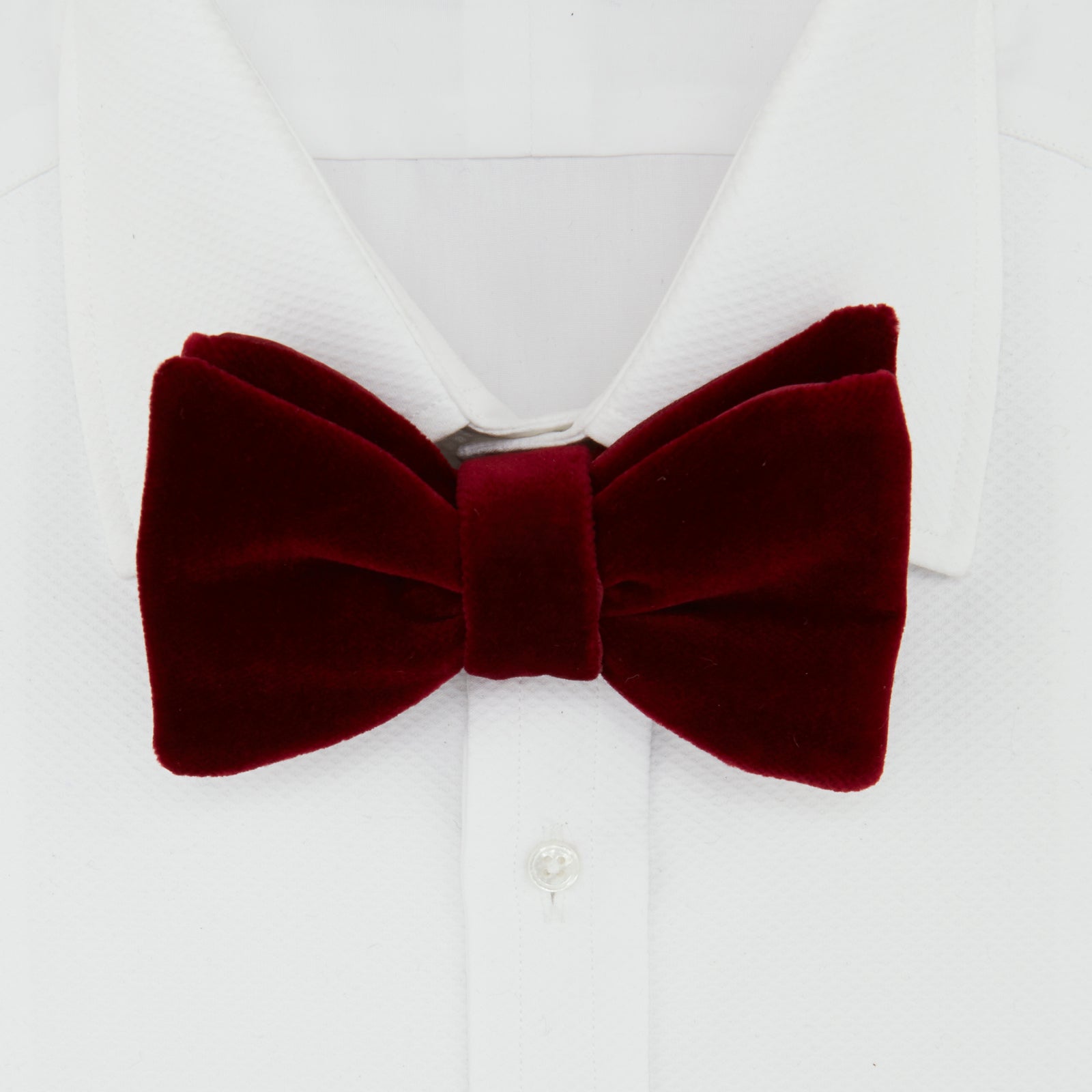 View 2 of product The Turnbull & Asser Burgundy Velvet Bow Tie features a soft, plush texture and is shown on a plain white background—an ideal accessory for formal soirées.