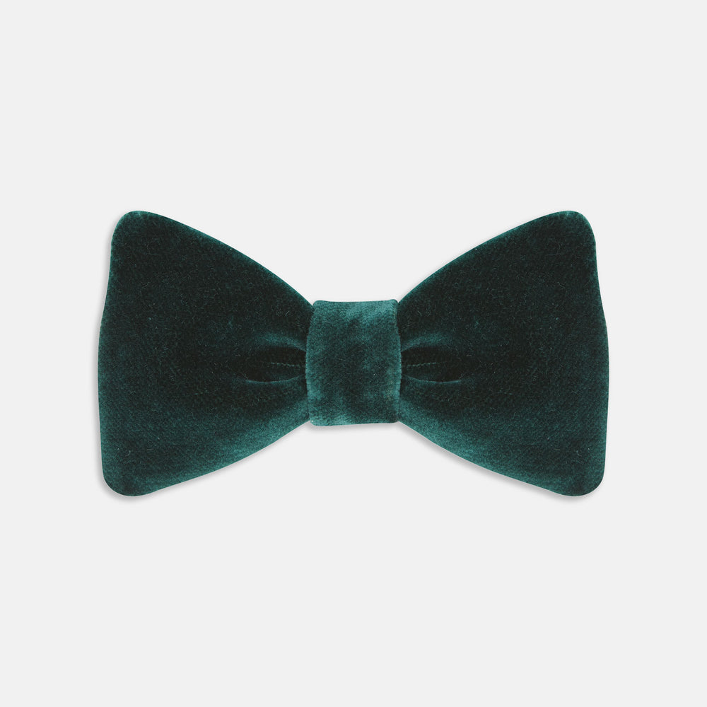 The Turnbull & Asser Green Velvet Bow Tie features a rich dark green hue and plush, smooth texture, ideal for formal events. Shown here against a plain white background.