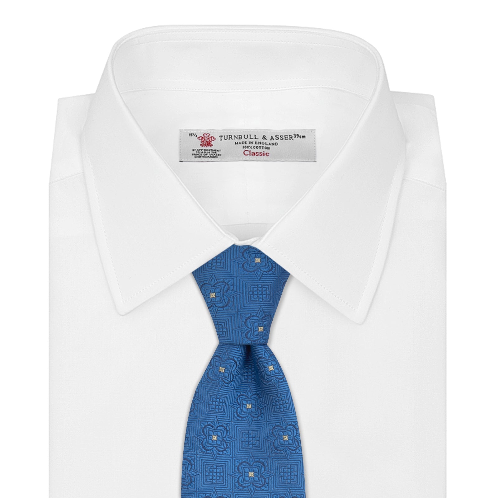 View 2 of product The Turnbull & Asser Blue Flower Mosaic Silk Tie features a blue silk fabric with a detailed geometric and floral design, accented in lighter blue and white, displayed on a white background.