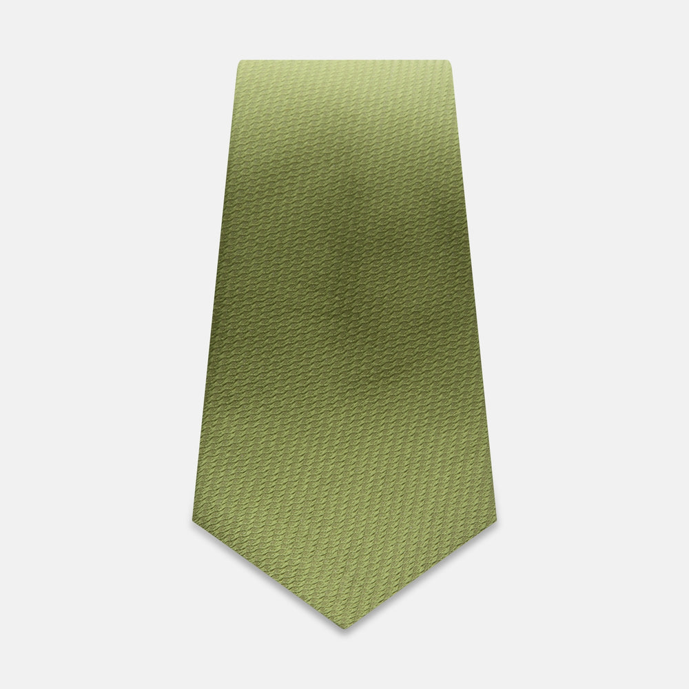 The Turnbull & Asser Green Lace Silk Tie features a light green hue and subtle lace weave, presented on a plain white background for enhanced texture.