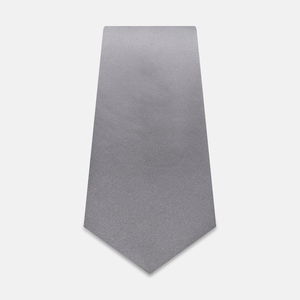 The Grey Satin Silk Tie by Turnbull & Asser is displayed vertically against a white background—its solid light grey silk and satin finish make it an elegant choice for a spring wedding.