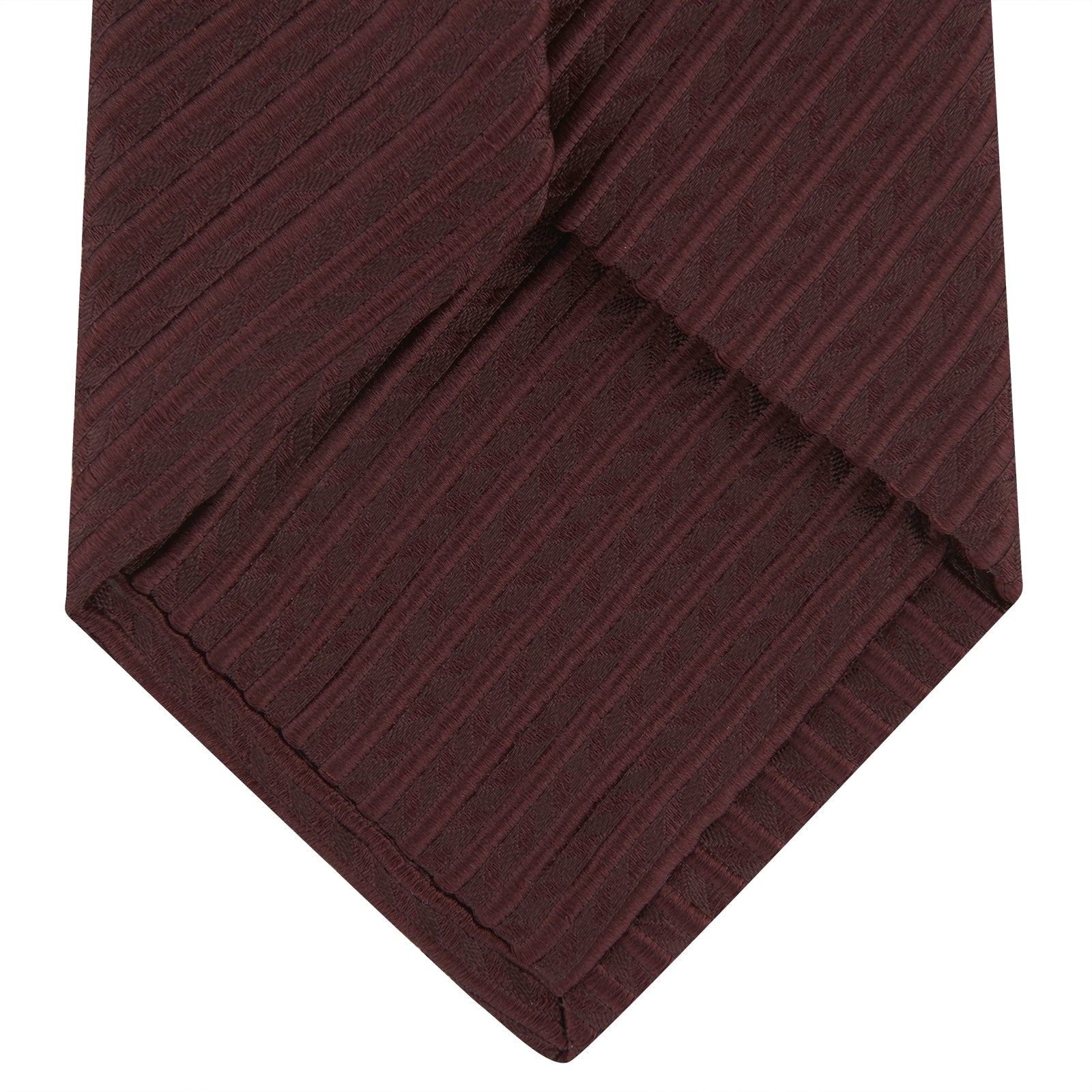 View 4 of product The Turnbull & Asser Burgundy Ottoman Silk Tie features a heavyweight ribbed silk with a subtle diagonal wave pattern, shown rolled up on a plain white background.