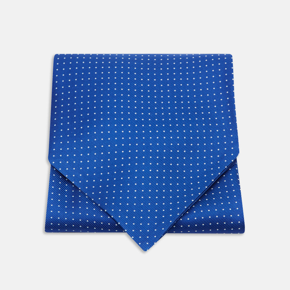 The Turnbull & Asser Royal Blue and White Small Spot Silk Ascot Tie, featuring fine white dots on blue silk, is shown on a plain white background—an elegant finishing touch for any wedding guest outfit.