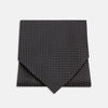 View 1 of product The Turnbull & Asser Black and White Mini Spot Silk Cravat, featuring a refined polka dot pattern, is displayed elegantly on a plain light background—an ideal wedding guest accessory.