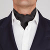 View 2 of product The Turnbull & Asser Black and White Mini Spot Silk Cravat, featuring a refined polka dot pattern, is displayed elegantly on a plain light background—an ideal wedding guest accessory.